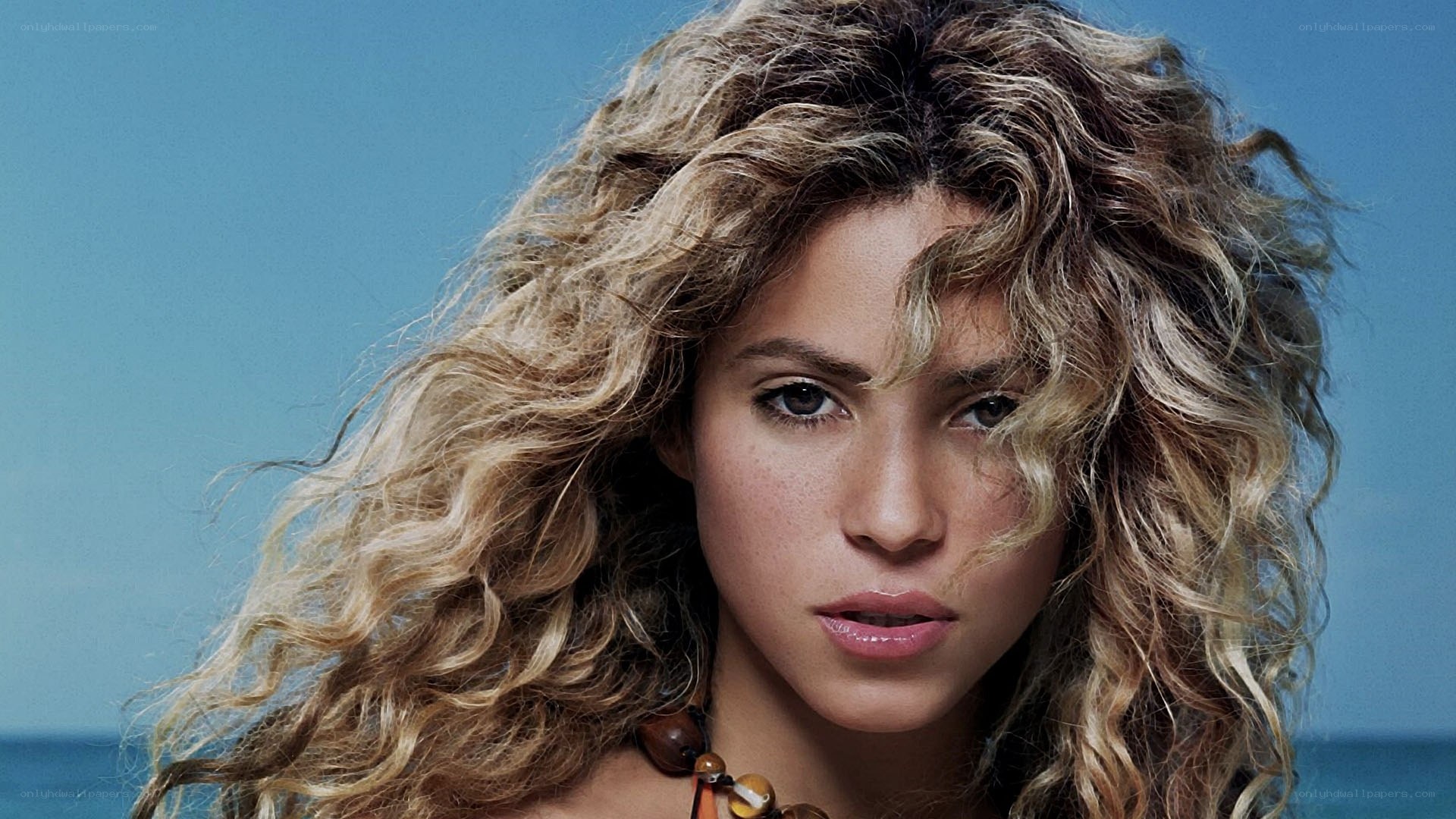 woman with curly hair at beach