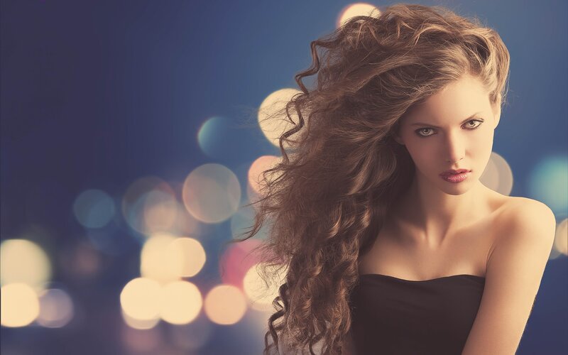 woman with curly hair at night