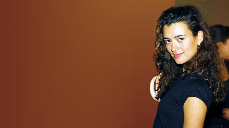Woman with Curly Hair — Brown, Neutral, Photograph, Black Shirt, Brown Wall