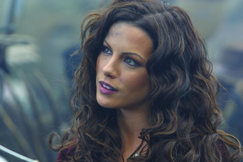 Woman with Curly Hair — Brown, Serious, Photograph, Necklace, Makeup, Purple