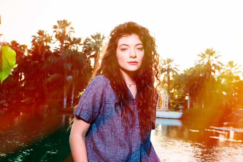 woman with curly hair by water