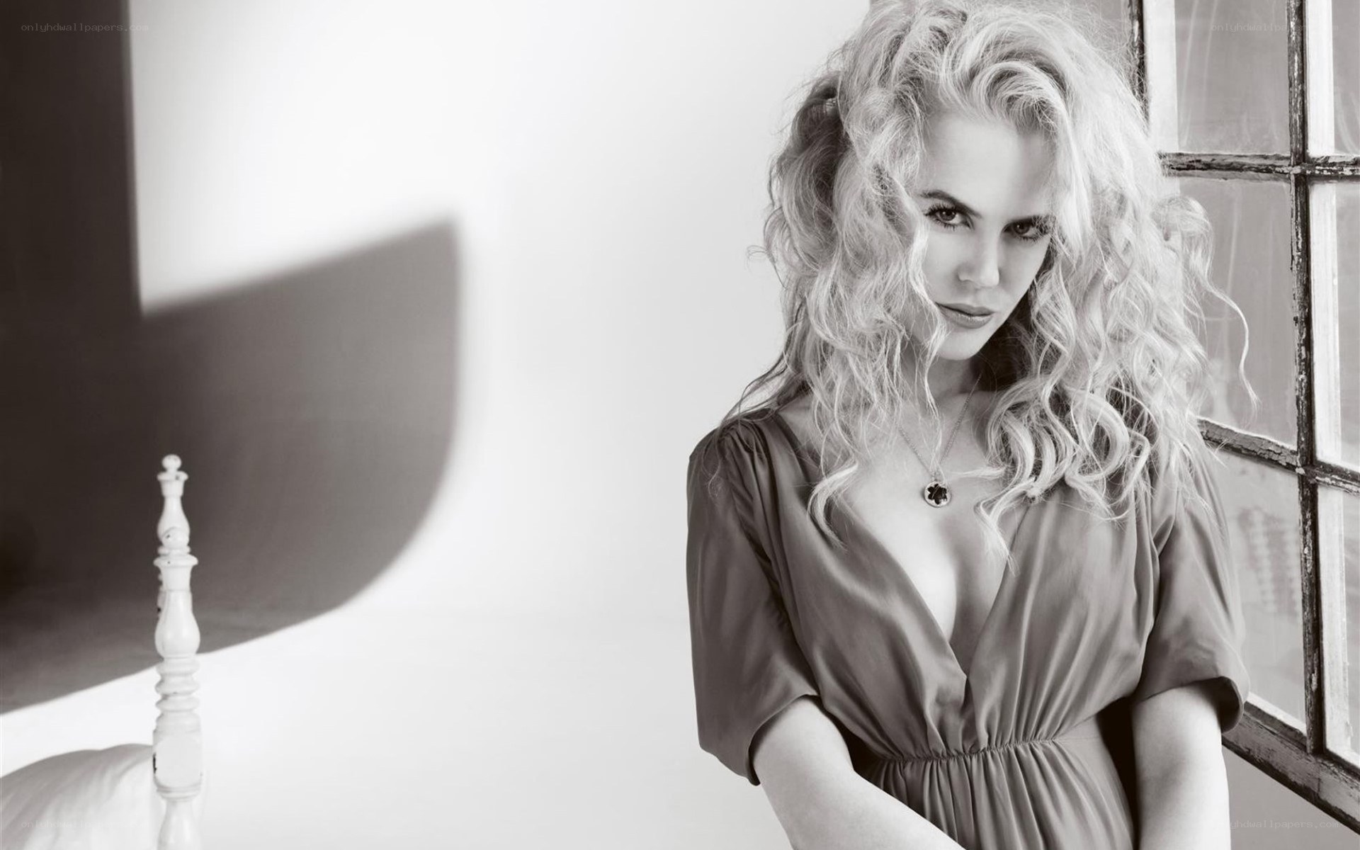 woman with curly hair by window