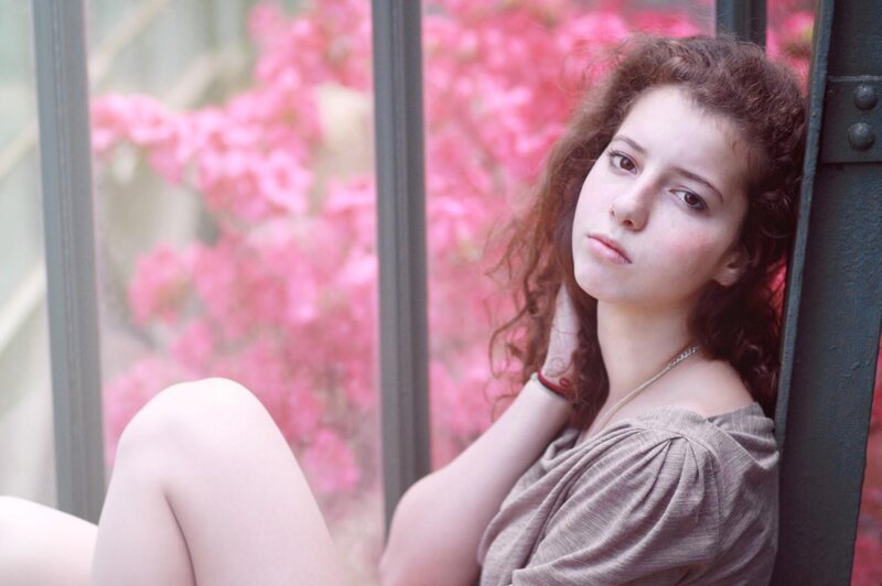 woman with curly hair by window