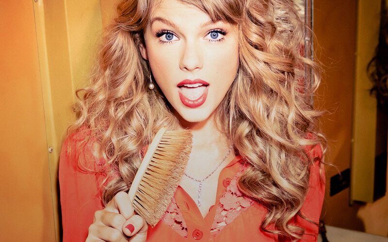 woman with curly hair holding brush