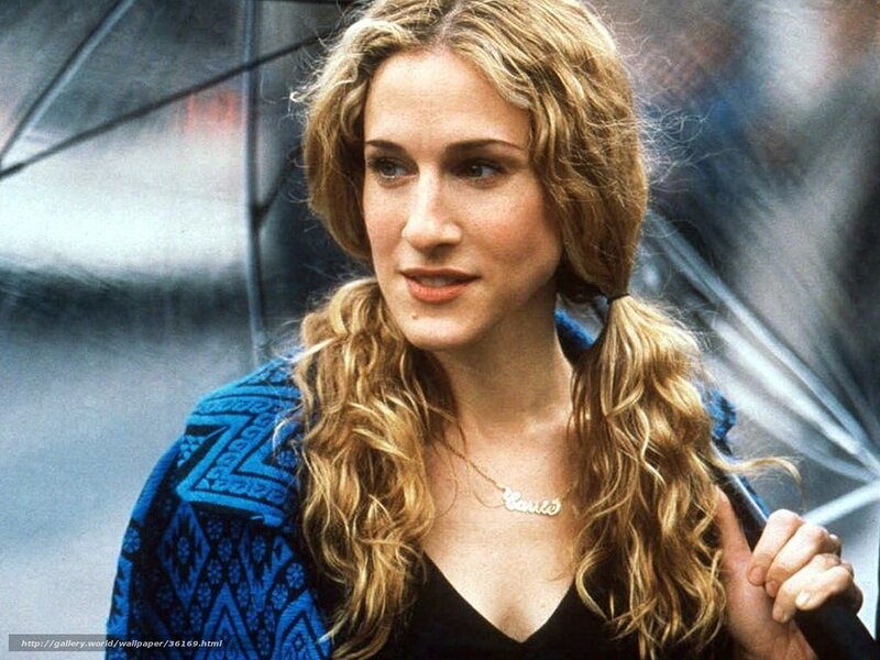 woman with curly hair holding umbrella