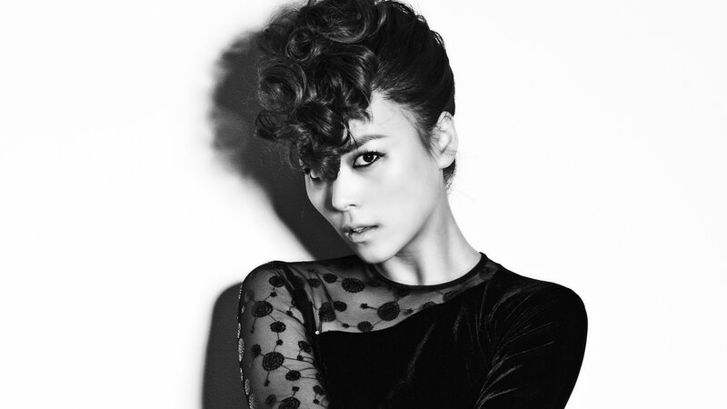 woman with curly hair in black and white