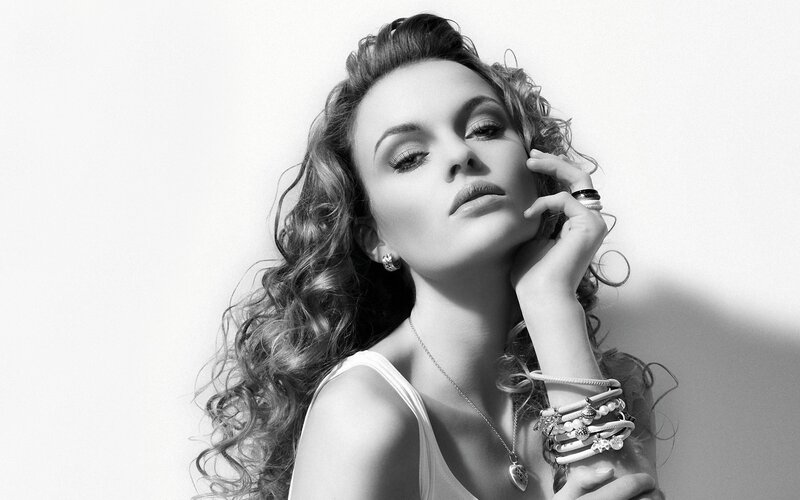 woman with curly hair in black and white