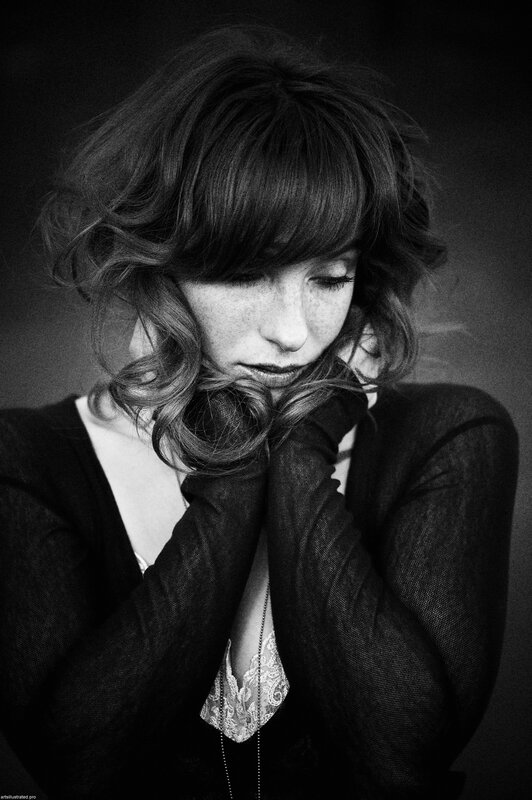 woman with curly hair in black and white