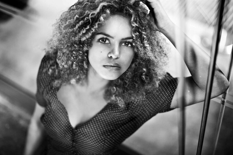 woman with curly hair in black and white