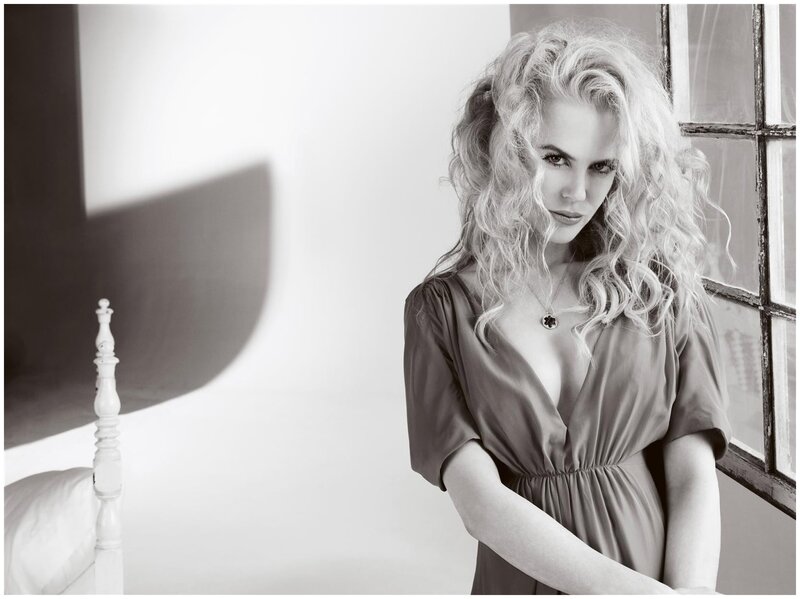 woman with curly hair in black and white
