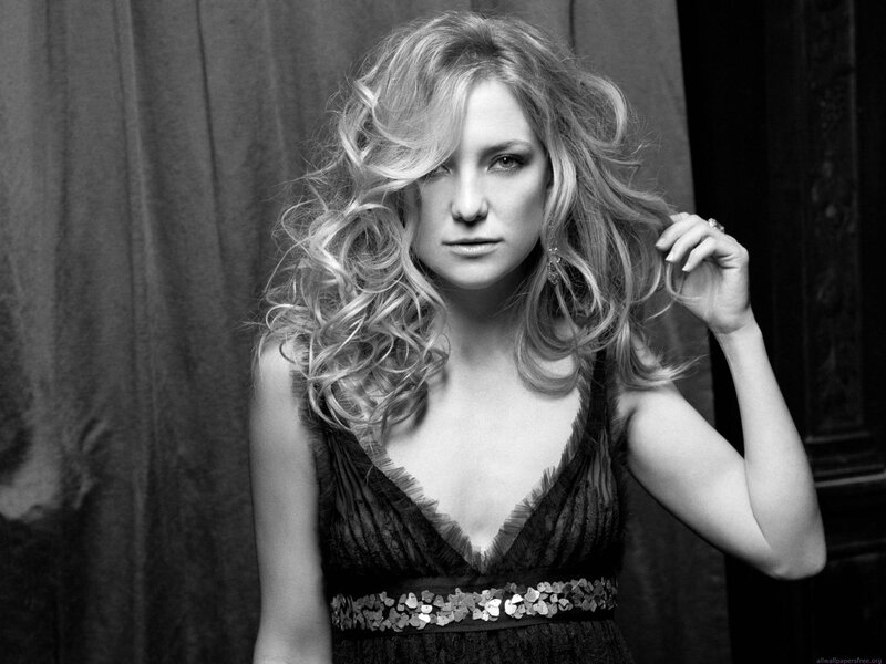 woman with curly hair in black dress