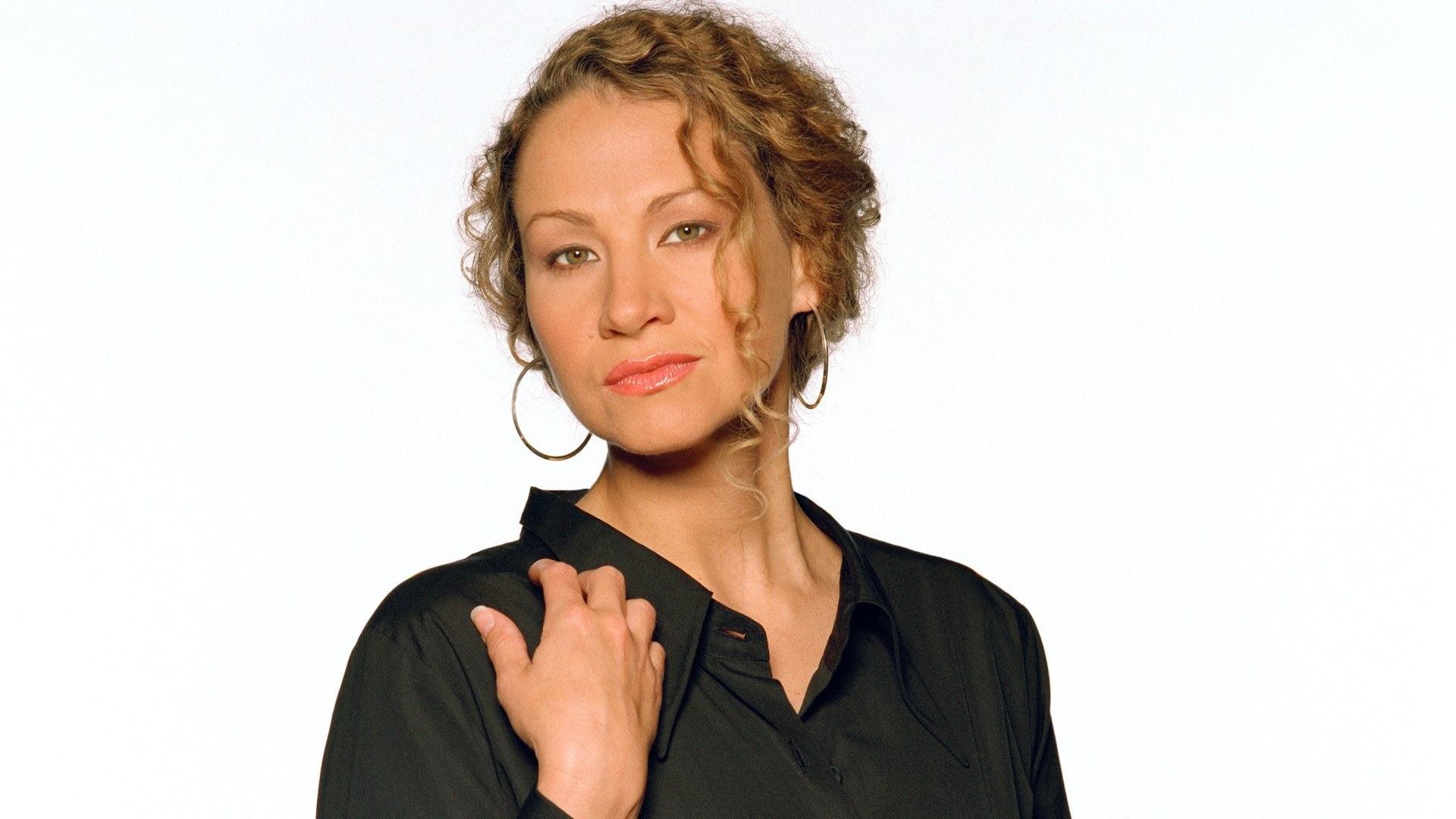 woman with curly hair in black shirt