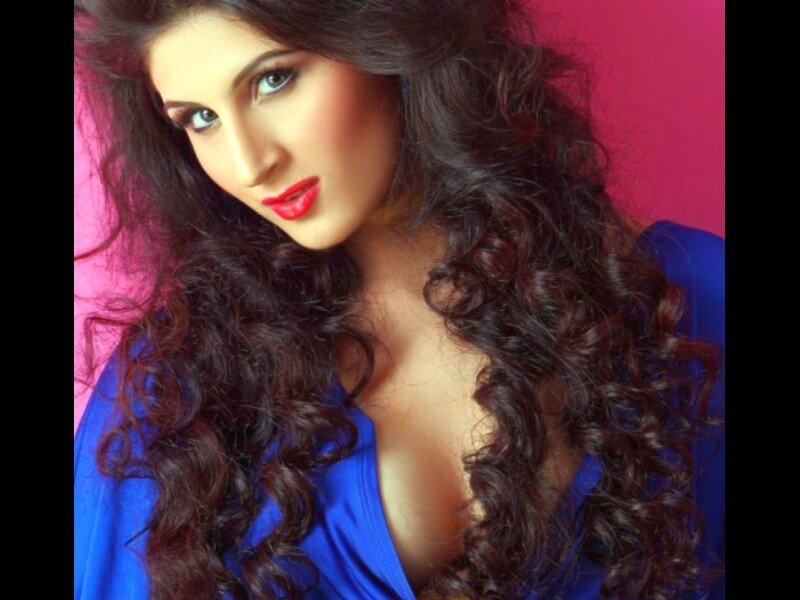 woman with curly hair in blue top