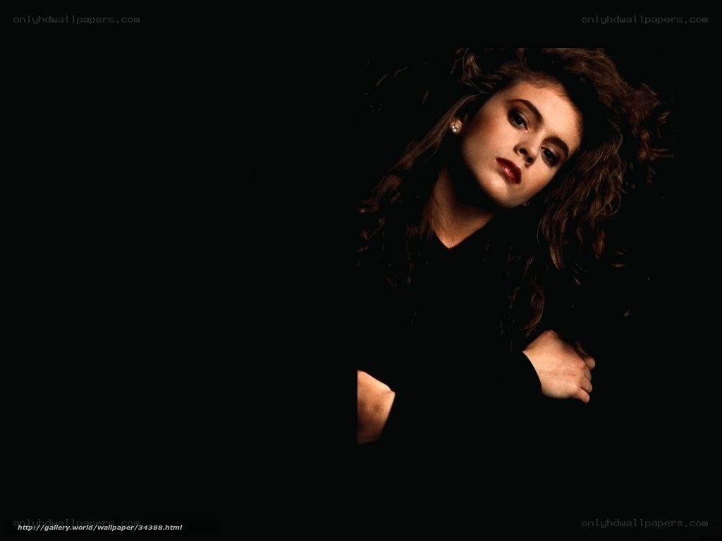 woman with curly hair in dark setting