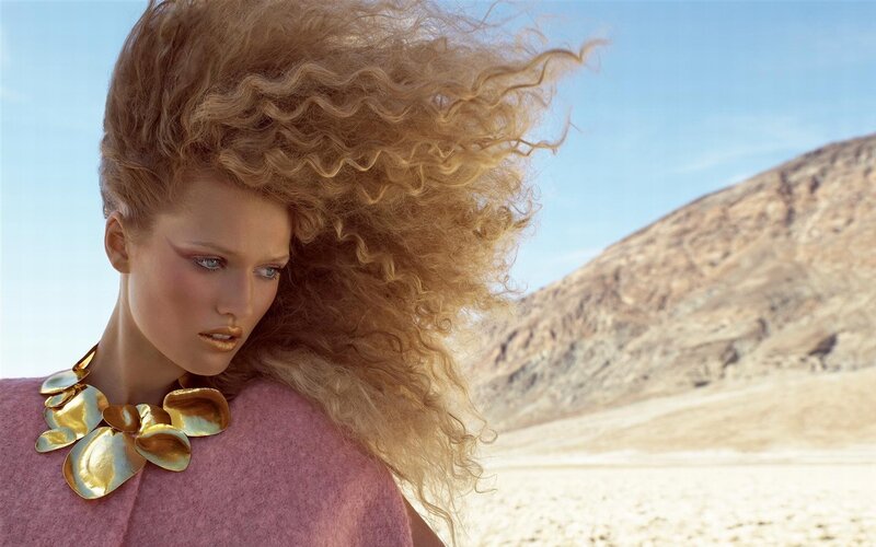 woman with curly hair in desert