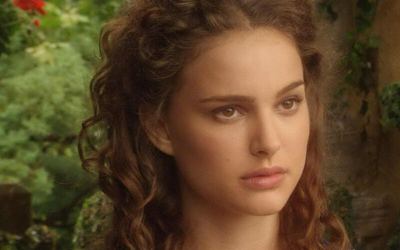 woman with curly hair in garden