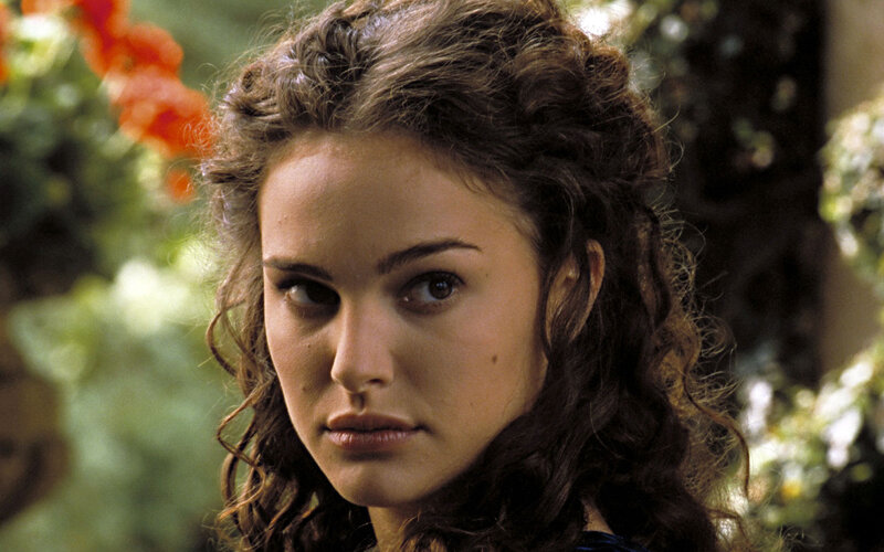 woman with curly hair in garden