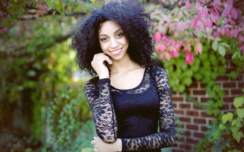 woman with curly hair in garden