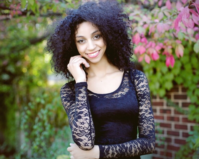woman with curly hair in garden