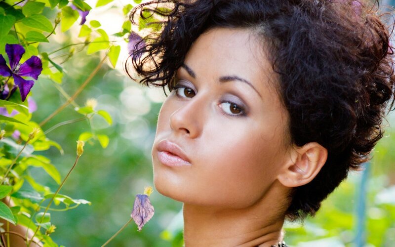 woman with curly hair in garden
