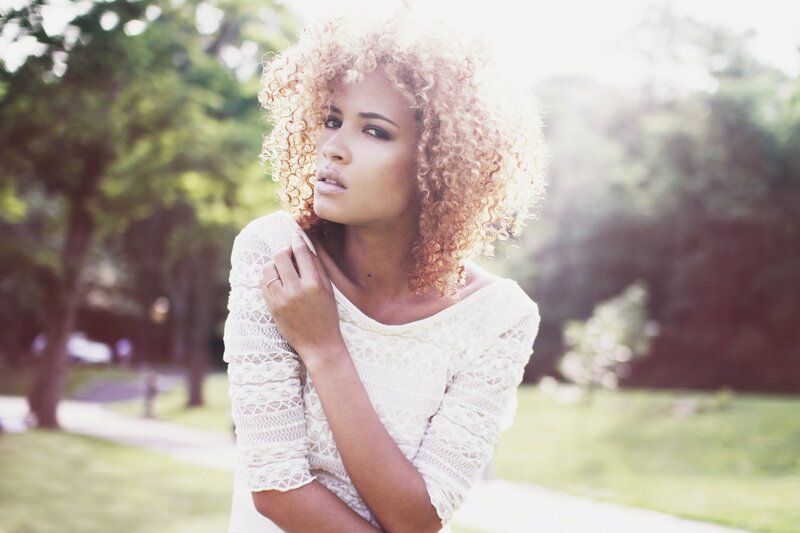 woman with curly hair in park