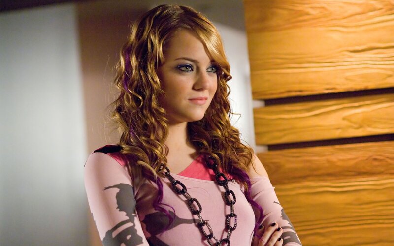 woman with curly hair in pink top