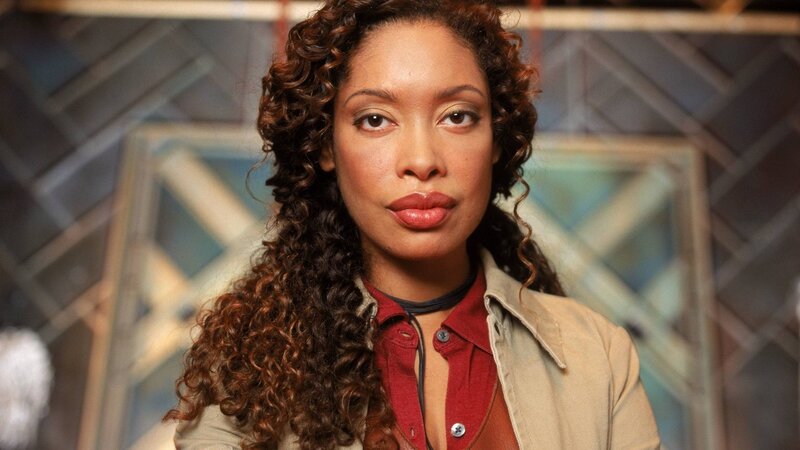 woman with curly hair in red shirt