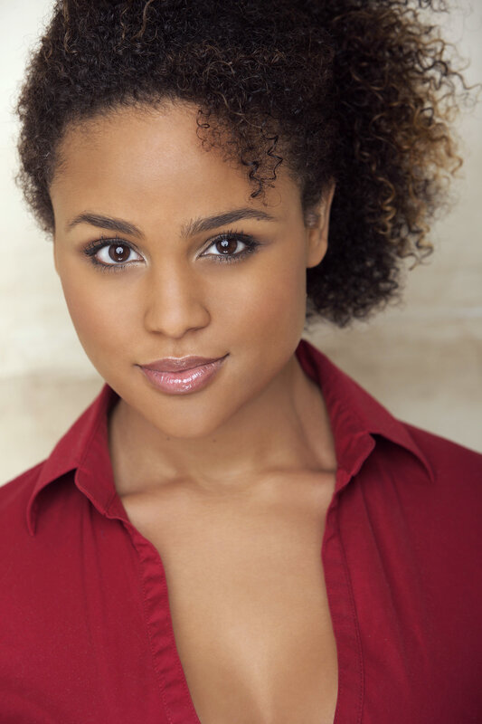 woman with curly hair in red shirt
