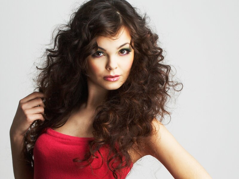 woman with curly hair in red top