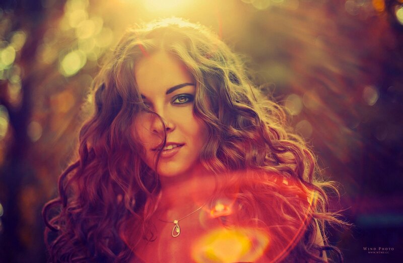 woman with curly hair in sunlight