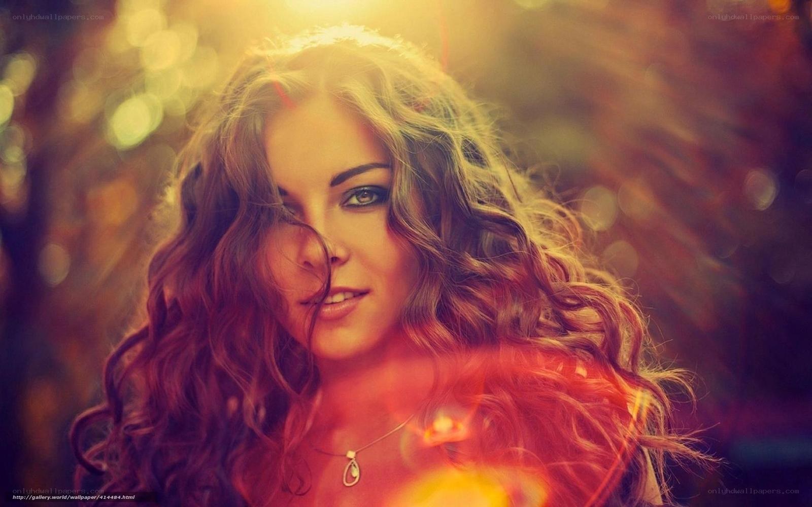 woman with curly hair in sunlight