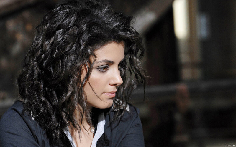 woman with curly hair looking down