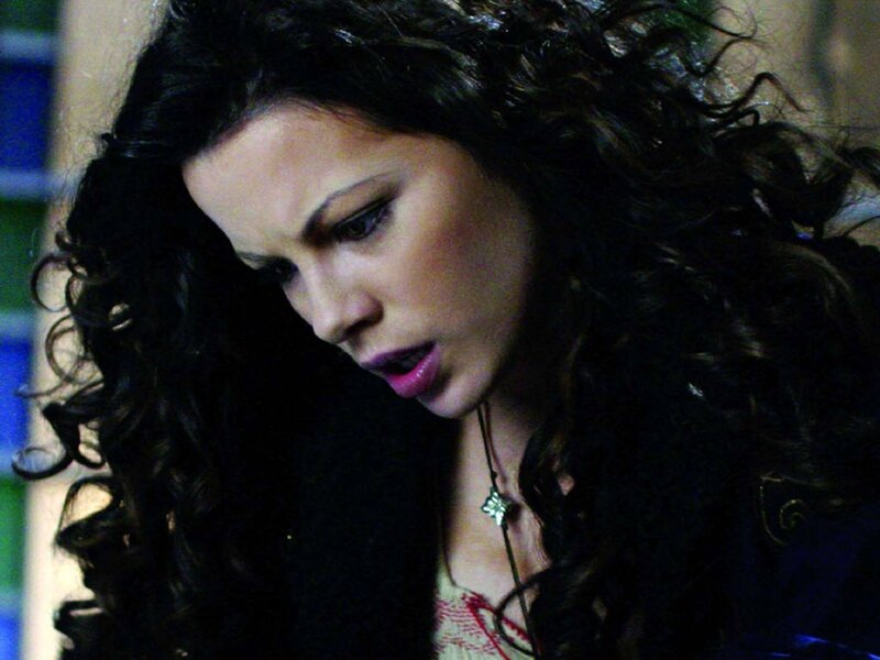 woman with curly hair looking down