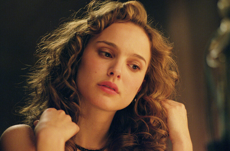 woman with curly hair looking down