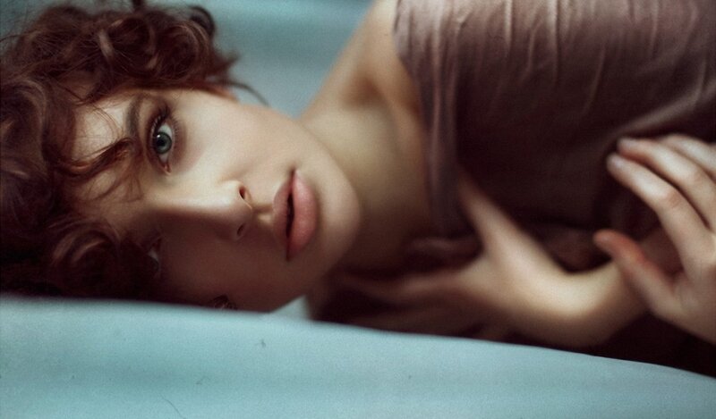 woman with curly hair lying down