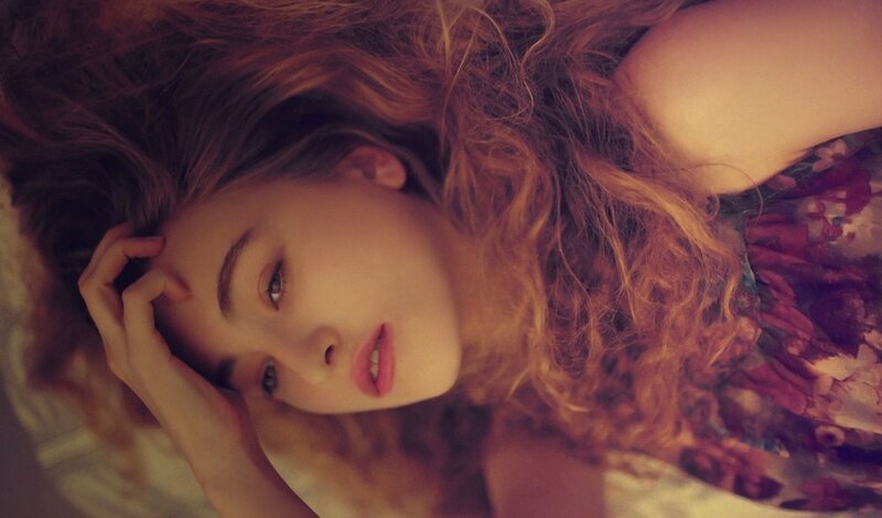 woman with curly hair lying down