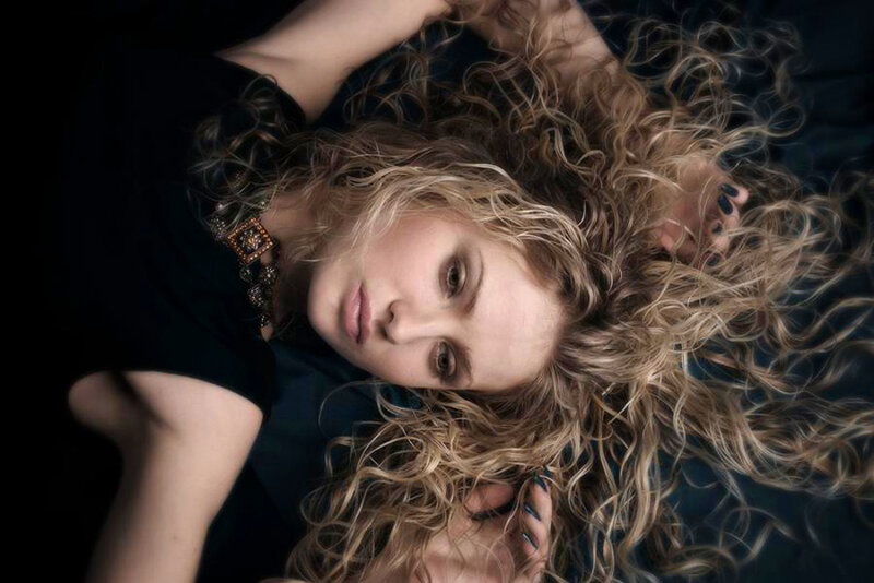 woman with curly hair lying down