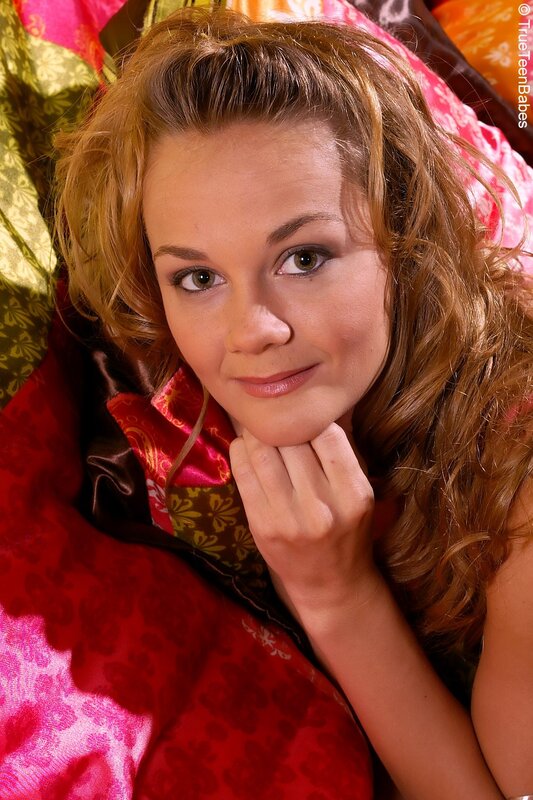woman with curly hair on colorful blanket