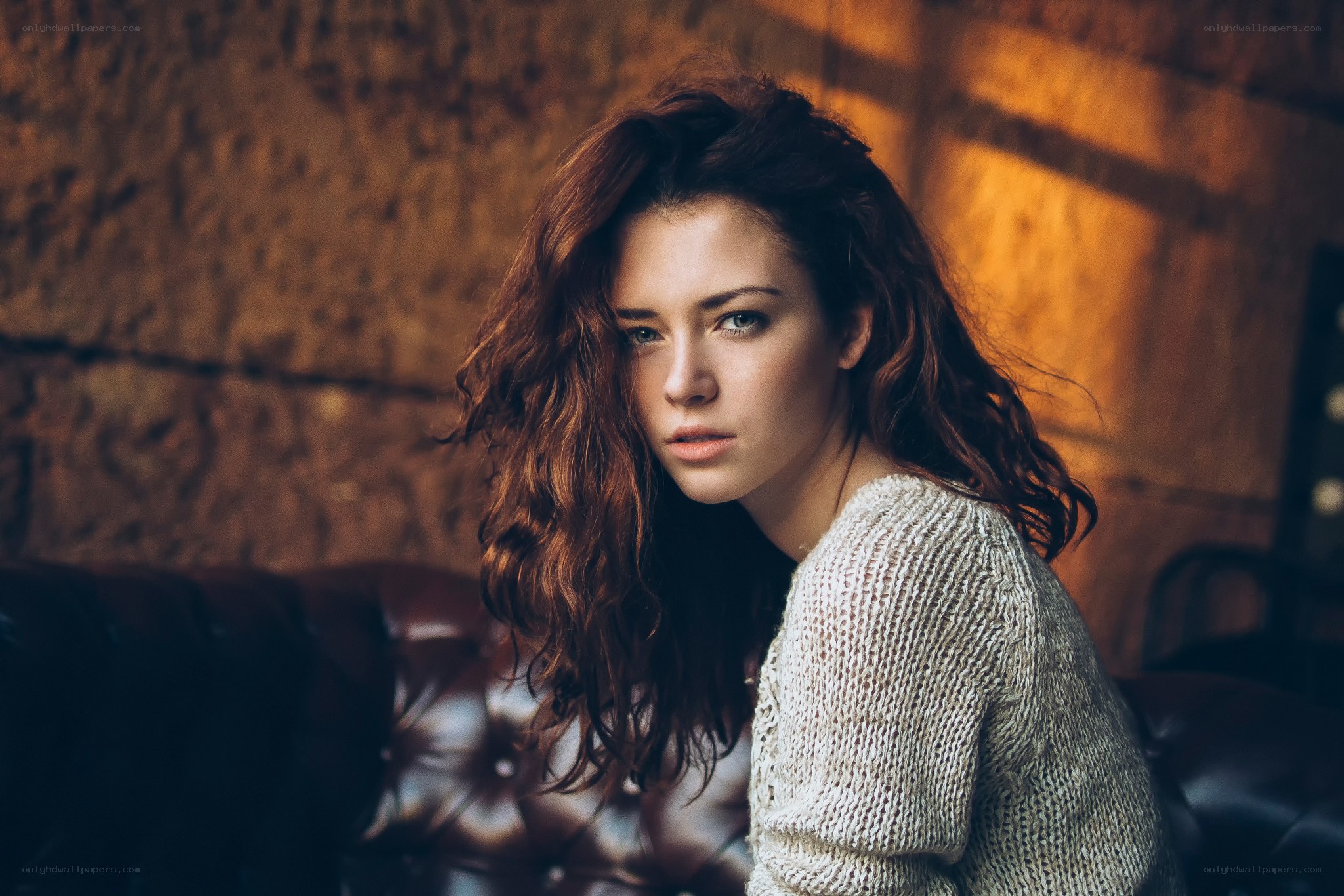 woman with curly hair on couch