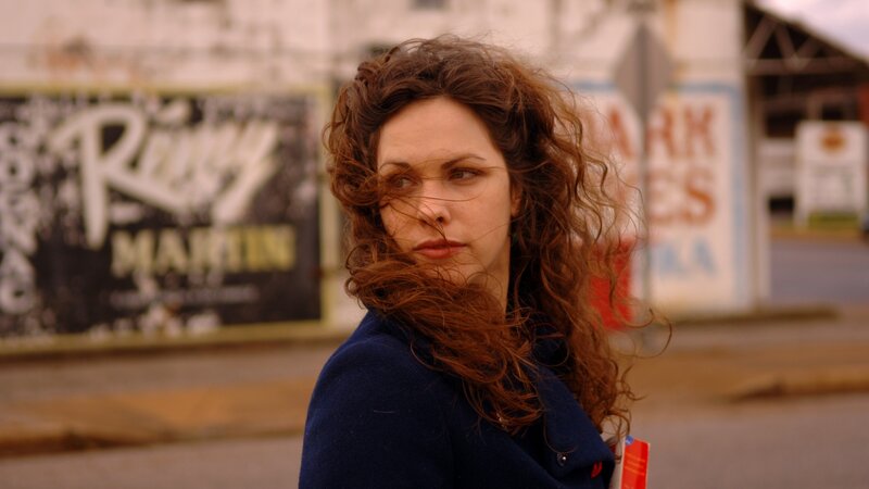 woman with curly hair on street