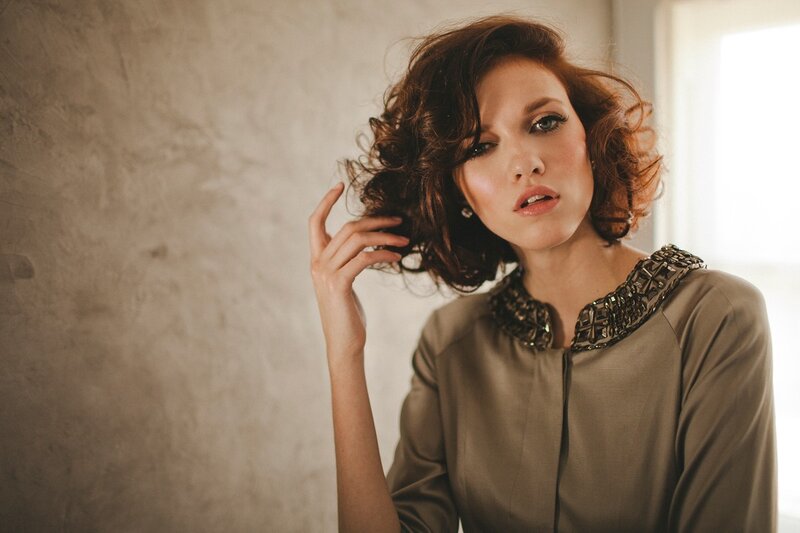 woman with curly hair posing