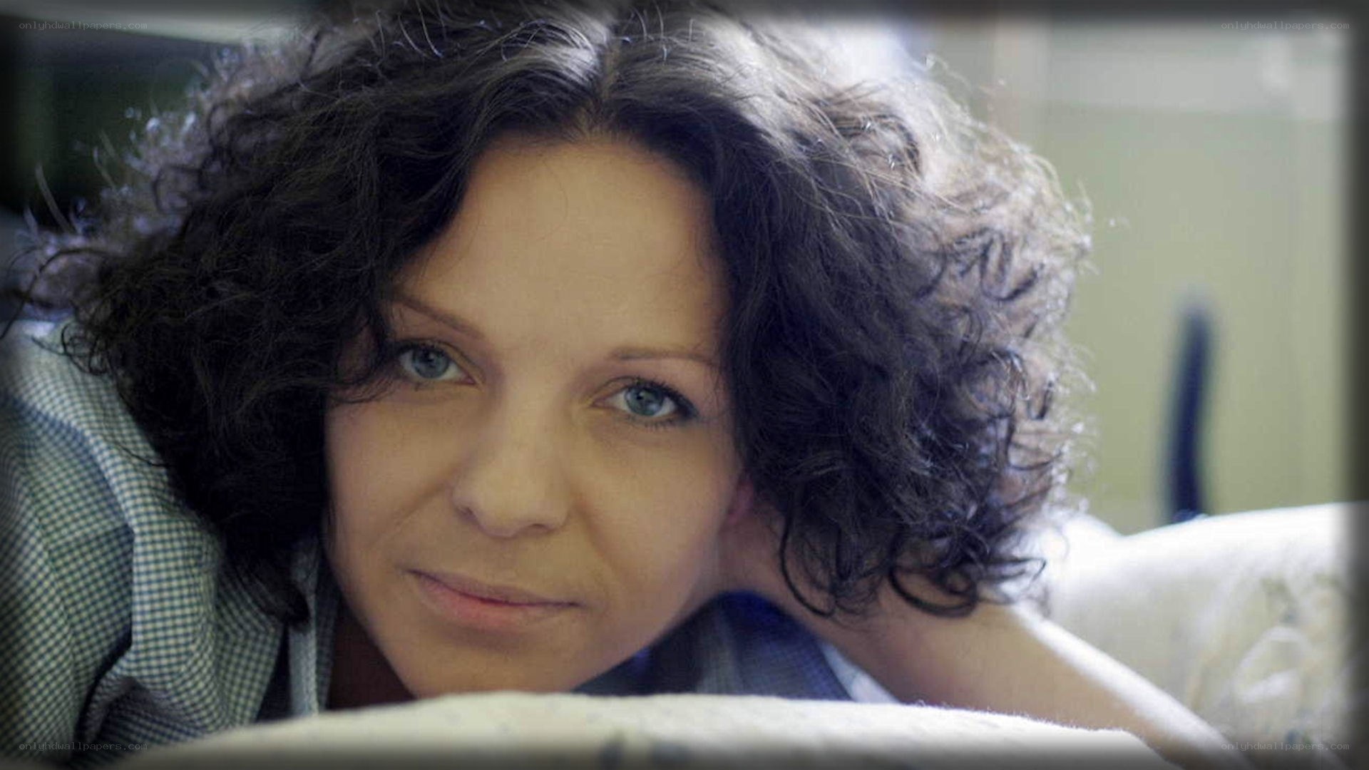 woman with curly hair resting