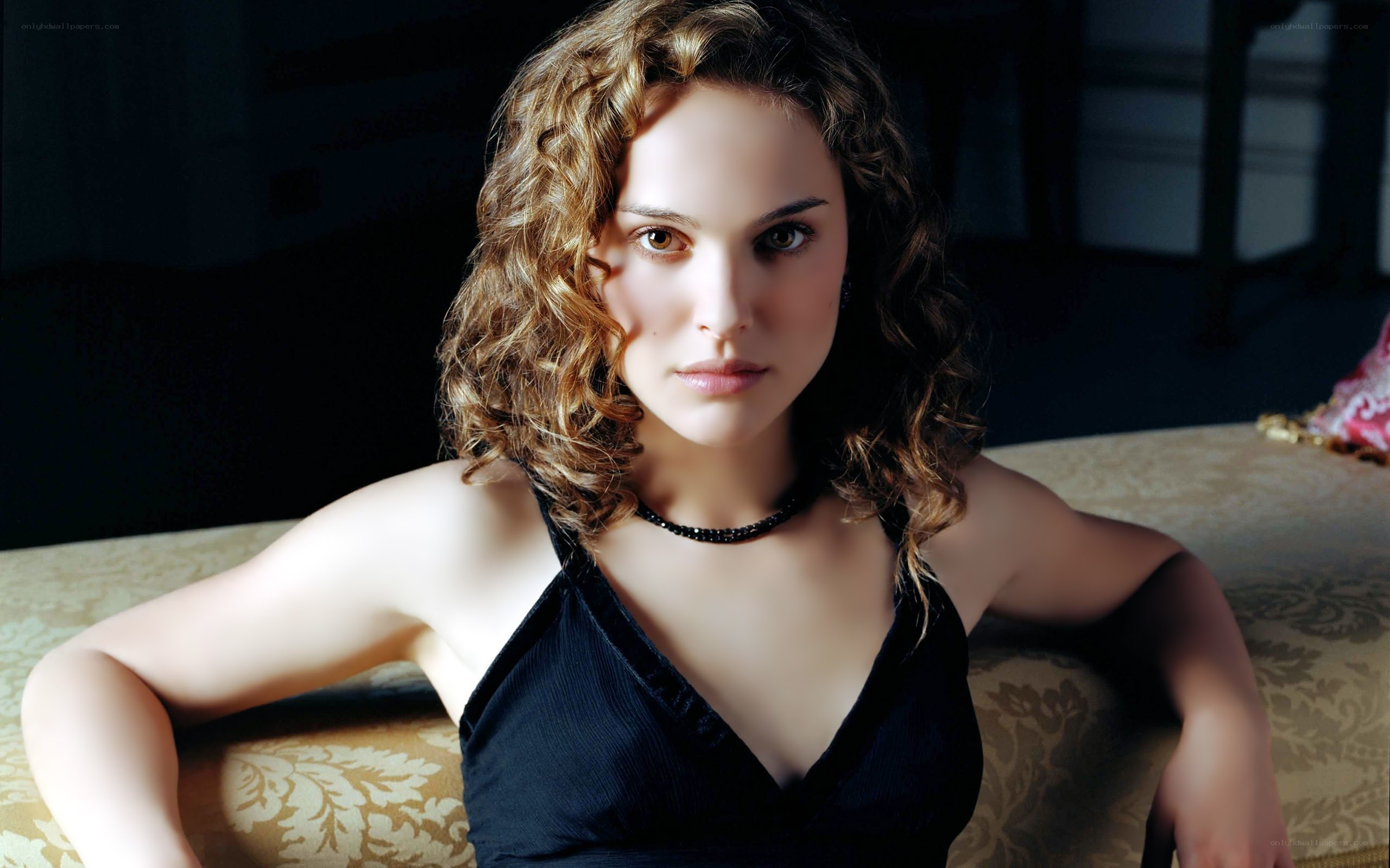 woman with curly hair sitting