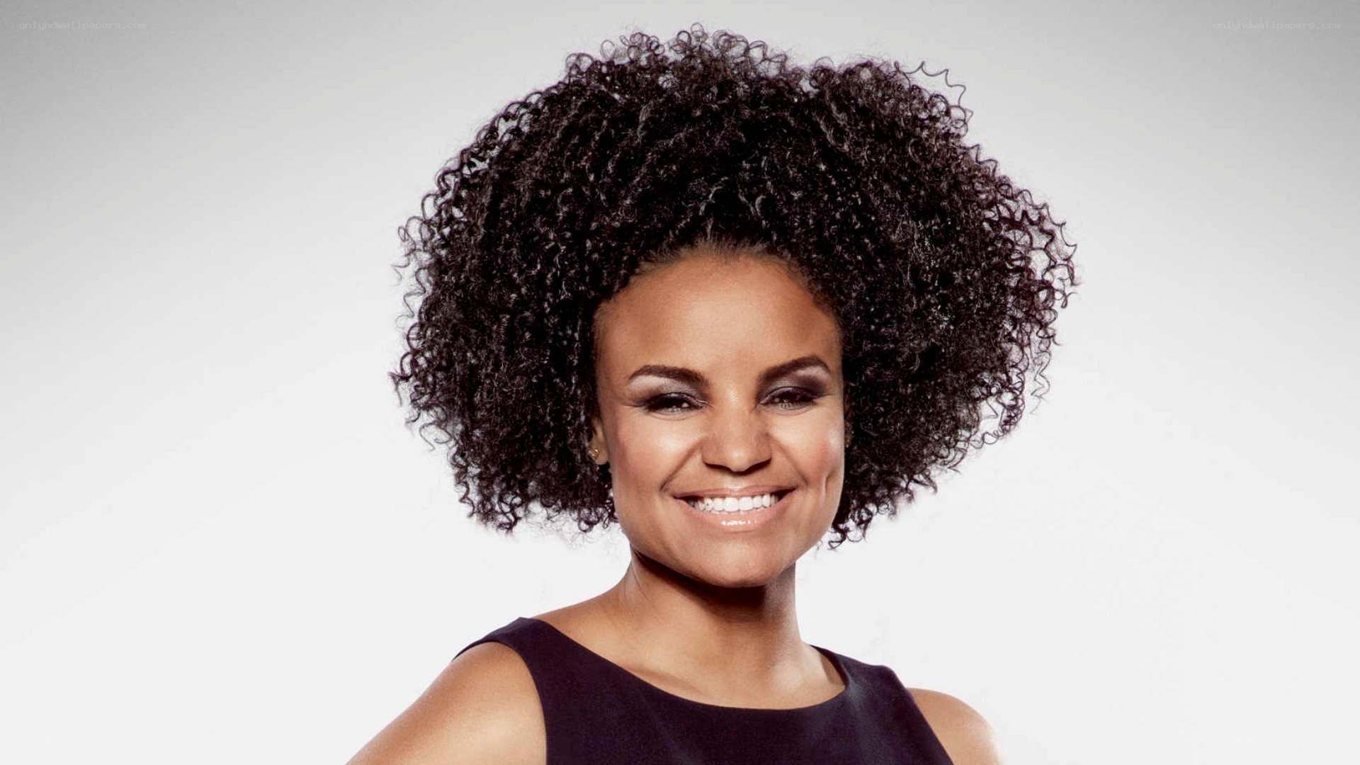 woman with curly hair smiling