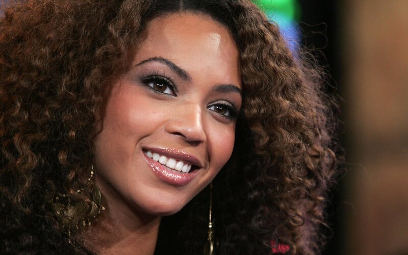 woman with curly hair smiling
