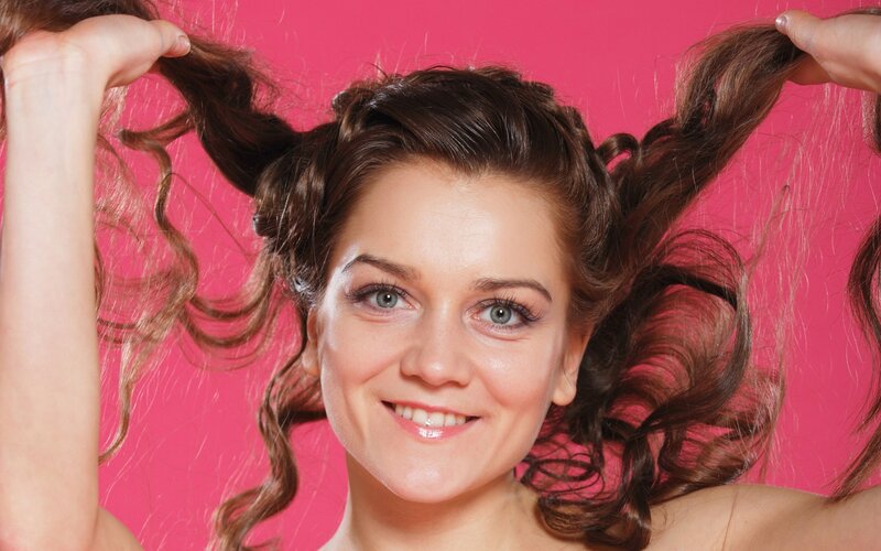 woman with curly hair smiling