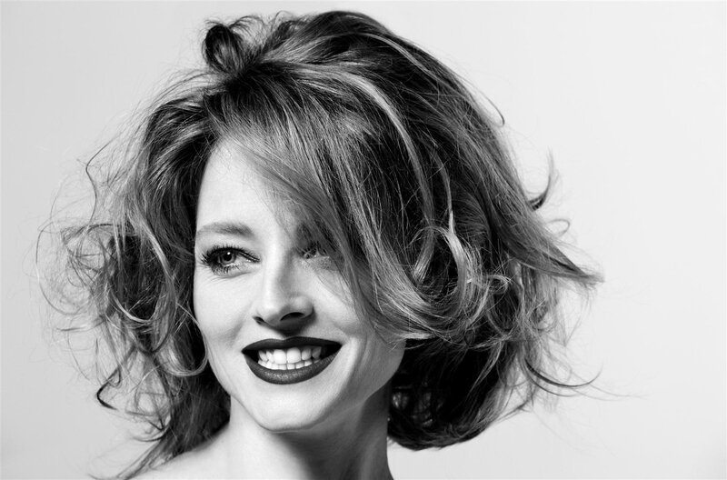 woman with curly hair smiling