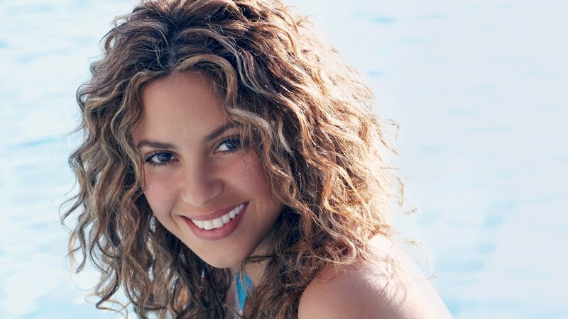 woman with curly hair smiling