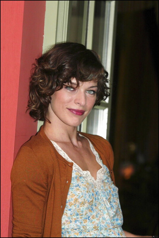 woman with curly hair smiling