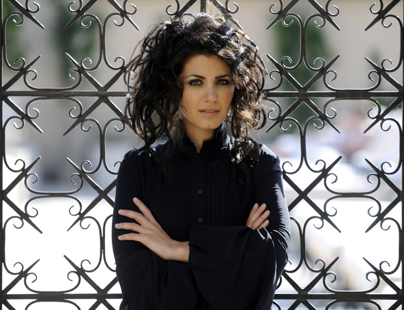 woman with curly hair standing